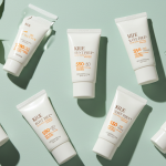 A flat lay of 5 of the best Korean sunscreens for oily and acne-prone skin on a clean, minimalist background.