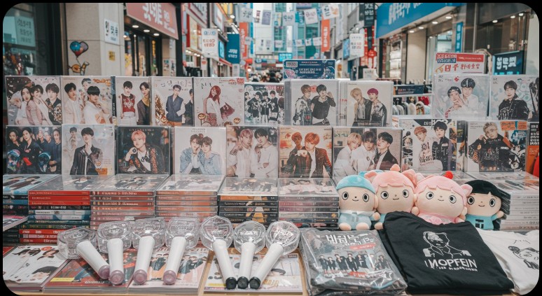 A display of K-Pop albums and official merch, a must-buy Korean souvenir for fans.