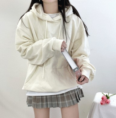 The 'K-student' look, with an oversized hoodie layered over a pleated skirt and paired with a beret.