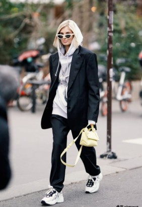A polished look featuring an oversized hoodie layered under a chic blazer.